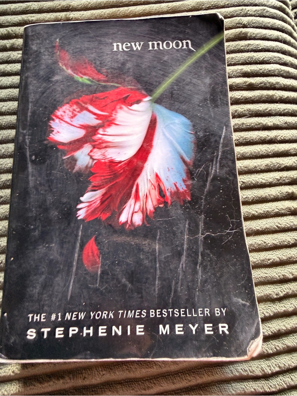 New Moon Paperback by Stephenie Meyer — Black Cover with Red & Blue Flower